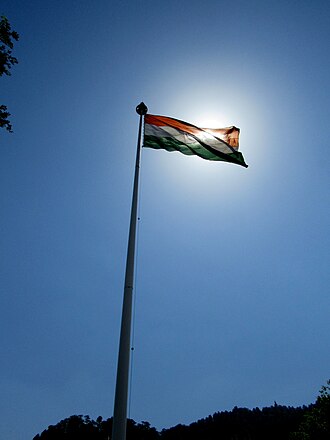 Indian flag backlit by bright sun Shimla, India.